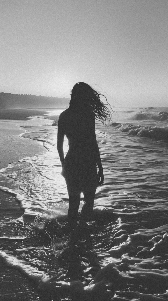 black and white photo of woman standing in the surf, grainy film noir style, beach at dusk, --ar 14:25 Job ID: f0da4e1d-33fd-4881-b704-2f16f4a4fc61